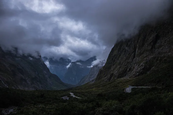 Gray clouds floating over amazing mountains and picturesque valley on South Island of New Zealand