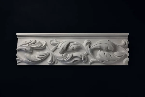 Stucco white  frieze on a black background.