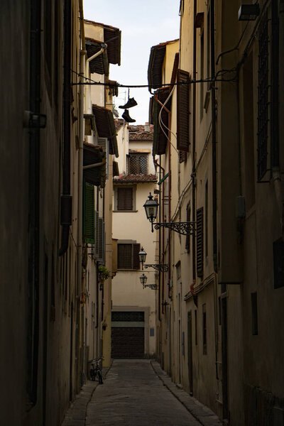 Florence narrow street with a pair of shoes hanging on a wire. shoe tossing.