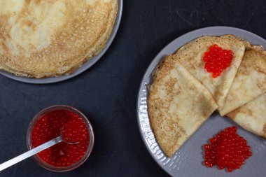 Blini üçgenler veya krep kavanoz ile plaka üzerinde kırmızı havyar ile