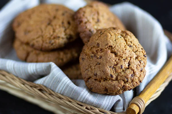 Homemade oatmeal cookies in basket with linen napkin