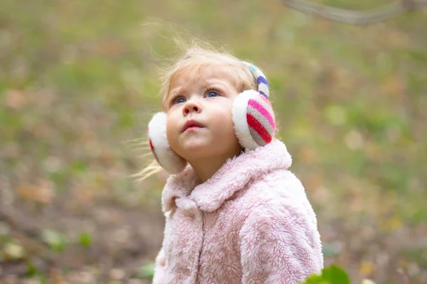 Linda menina lttle sério olhando para cima no parque de outono — Fotografia de Stock