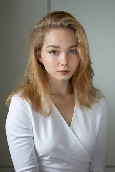 Portrait of the beautiful young woman in white dress looking at camera, — Stok Foto