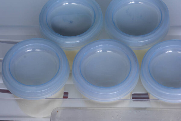 Breast milk storage containers stored in freezer