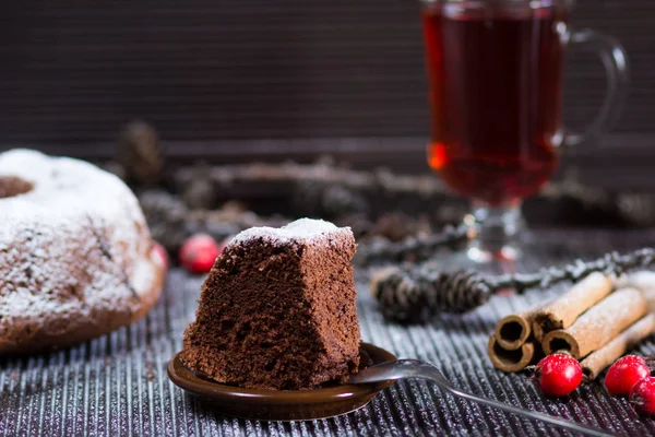 Piece of christmas chocolate sponge cake with sugar powder on wo — Stock Photo, Image