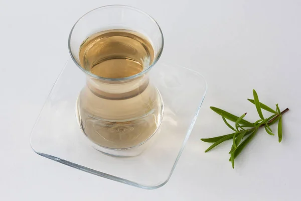 Rosemary tea in Armudu glass with branch of rosemary on white table as background — Stock Photo, Image