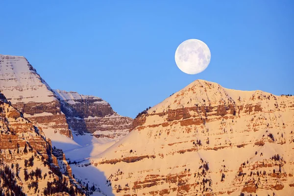 March Sunrise with a full moon in the Wasatch mountains, Utah, USA