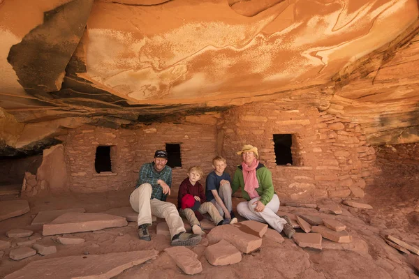 family portrait against  ruins of house of Native Americans in a desert canyon landscape, Utah, USA