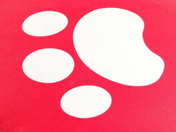 White Pet Paw Imprint on a Red Background