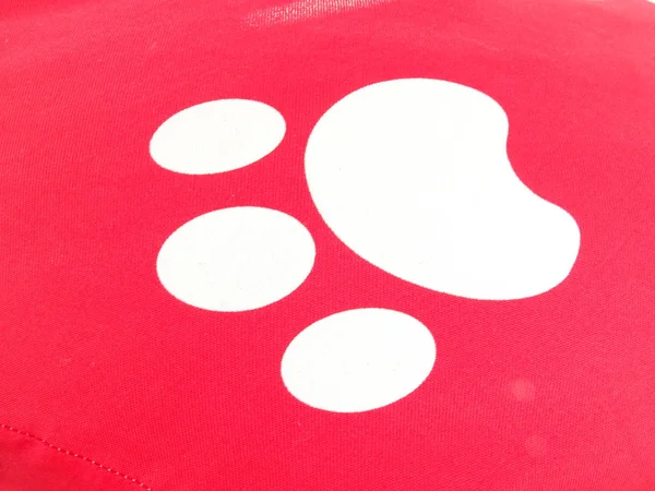 White Pet Paw Imprint on a Red Background