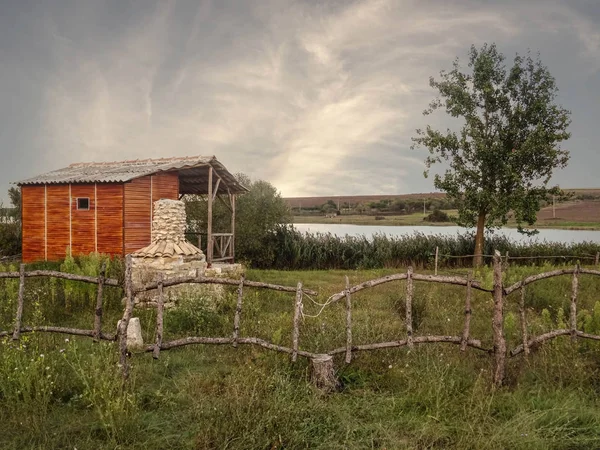 Wooden House on a Lake Coast