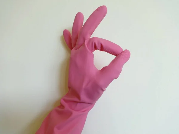 Hand with Pink Glove showing Okay Sign