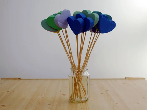 Colorful 3d Hearts on Wooden Sticks on a Wooden Table