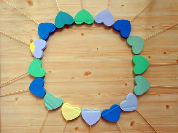 Colorful 3d Hearts on Wooden Sticks on a Wooden Background