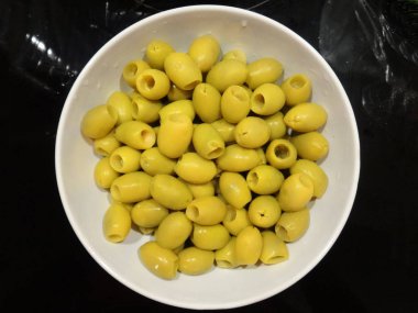 Beyaz bir kase çukurlara olmadan yeşil zeytin