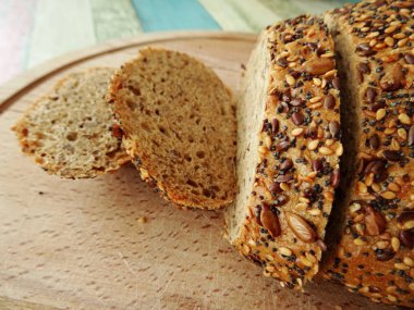 Susam ve tohumlar ahşap ekmek tahtası üzerinde ekmek dilimleri