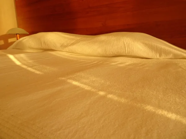Simple Bed with White Sheets