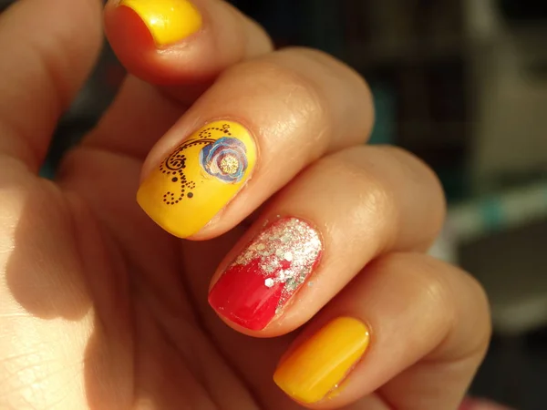 Yellow and Red Nail Polish Art with Glitter and Blue Flowers