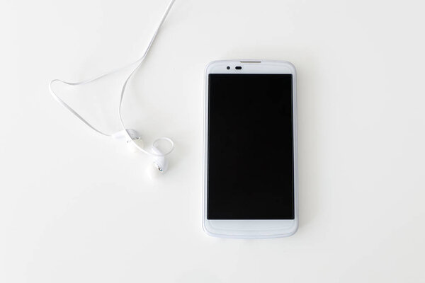 Modern White Smartphone with Headphones isolated on a White Back