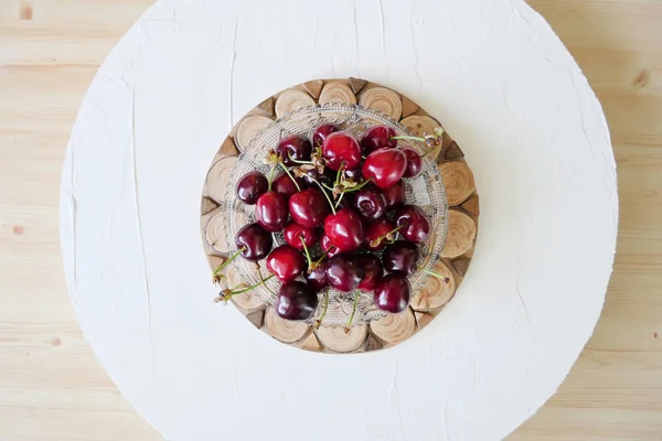 Fresh Dark Red Cherries in a Transparent Plate on a Wooden and W — Stock Photo, Image