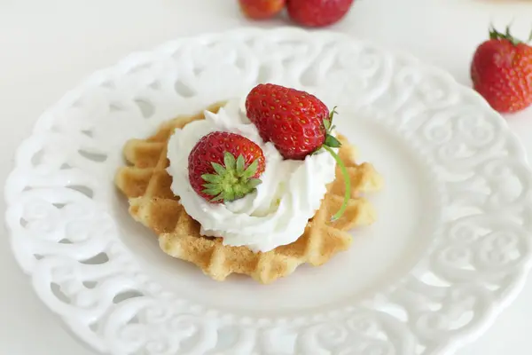 Gofre con crema y fresas en una placa blanca aislado en — Foto de Stock