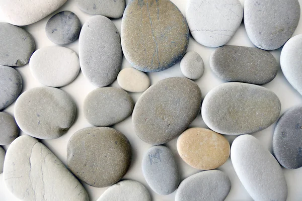 Piedras grises redondas aisladas sobre fondo blanco —  Fotos de Stock