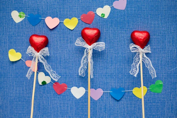 Three beautiful heart candies on stick
