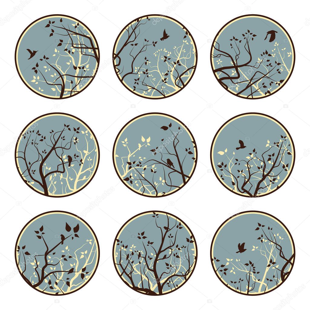 Set of round emblems of stylized tree branches and birds in blue tone.