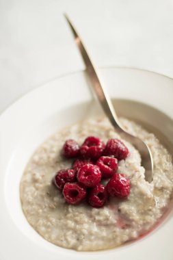 Ev yapımı rustik sağlıklı kahvaltı kavramı - yulaf ezmesi ahududu ve tatlım, zarif görsel tarz