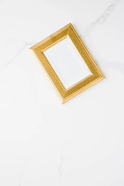 golden photo frame on marble, flatlay mockup - decor and mockup flatlay styled concept