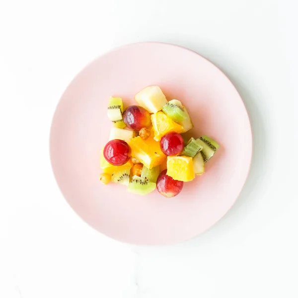 juicy fruit salad for breakfast on marble, flatlay - dieting and healthy lifestyle styled concept