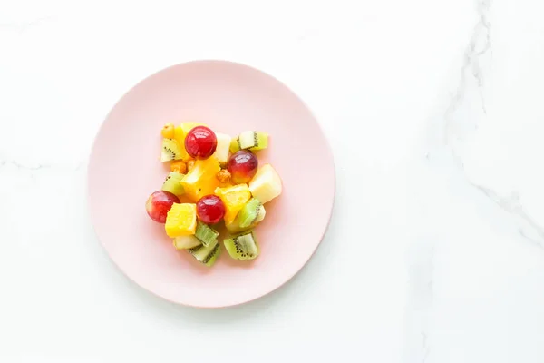 juicy fruit salad for breakfast on marble, flatlay - dieting and healthy lifestyle styled concept