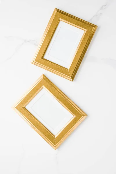 golden photo frame on marble, flatlay mockup - decor and mockup flatlay styled concept