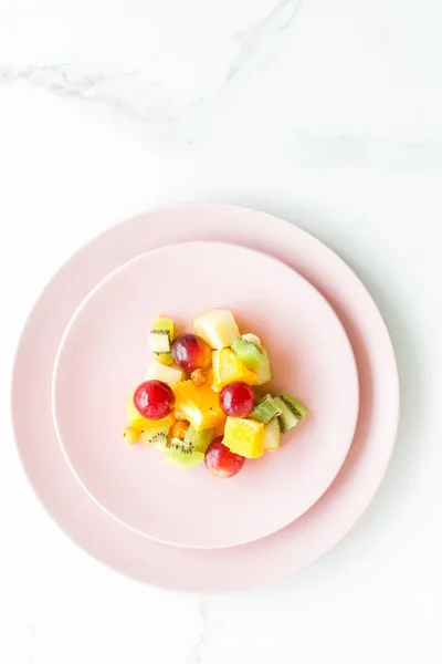 juicy fruit salad for breakfast on marble, flatlay - dieting and healthy lifestyle styled concept