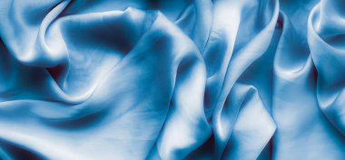 Mavi yumuşak ipek dalgalar, flatlay - şık kumaş dokular, arka ve modern pastel renklerle kavramı. Lüks dokunuş hissediyorum