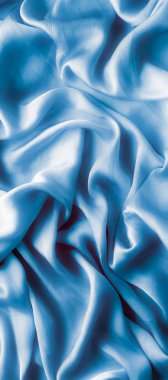 Mavi yumuşak ipek dalgalar, flatlay - şık kumaş dokular, arka ve modern pastel renklerle kavramı. Lüks dokunuş hissediyorum