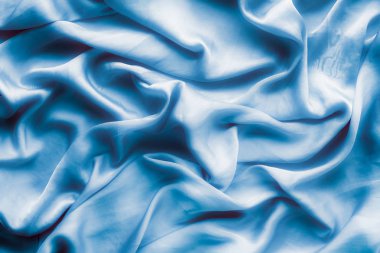 Mavi yumuşak ipek dalgalar, flatlay - şık kumaş dokular, arka ve modern pastel renklerle kavramı. Lüks dokunuş hissediyorum