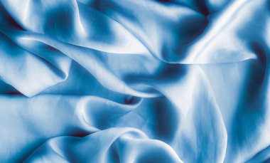 Mavi yumuşak ipek dalgalar, flatlay - şık kumaş dokular, arka ve modern pastel renklerle kavramı. Lüks dokunuş hissediyorum