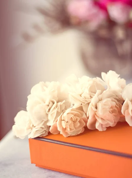 Present box and flowers for her - Mother's day ideas, happy giving and holiday inspiration concept. The perfect gift for mom