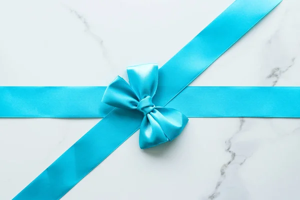 Blue silk ribbon on marble, top view — Stock Photo, Image