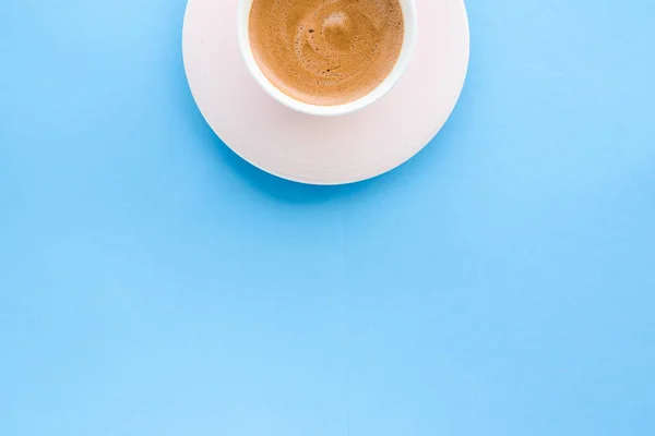 Hot aromatic coffee on blue background, flatlay