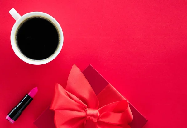 Luxury beauty gift box and coffee on red, flatlay