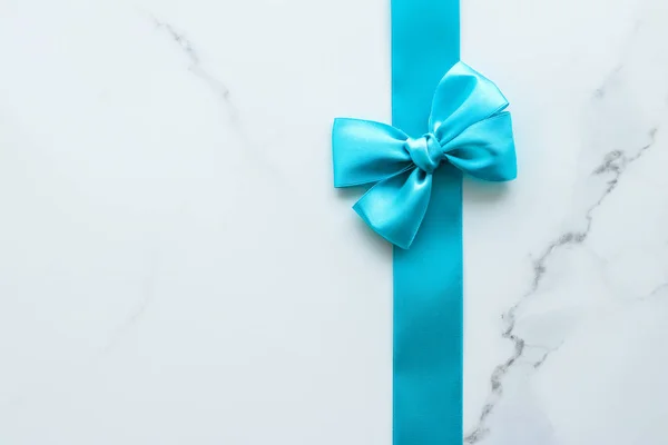 Blue silk ribbon on marble, top view — Stock Photo, Image