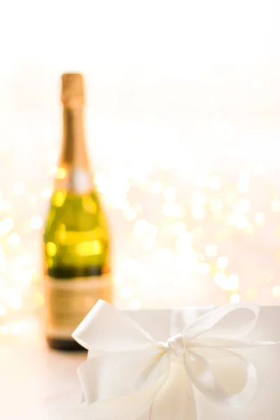 The bottle of champagne and holiday gift box — Stock Photo, Image