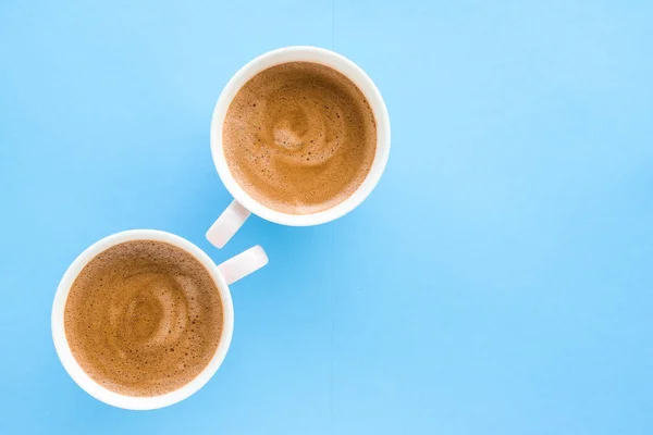 Hot aromatic coffee on blue background, flatlay