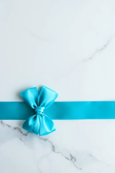 Blue silk ribbon on marble, top view — Stock Photo, Image