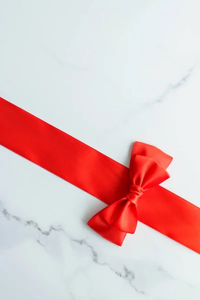 Red silk ribbon on marble, top view — Stock Photo, Image