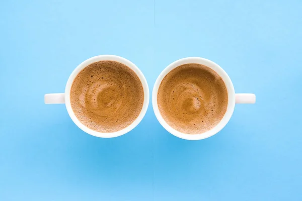 Hot aromatic coffee on blue background, flatlay