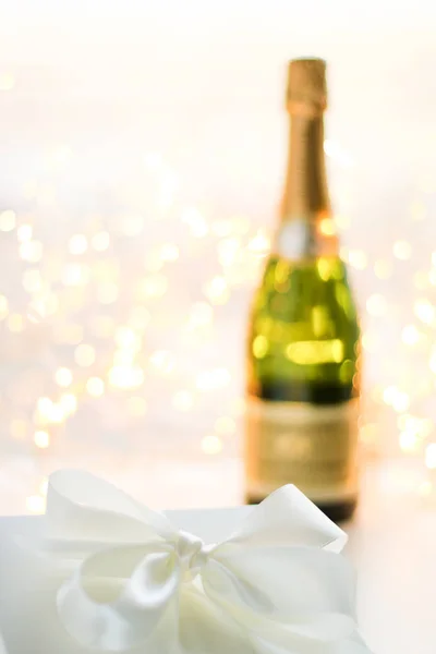 The bottle of champagne and holiday gift box — Stock Photo, Image