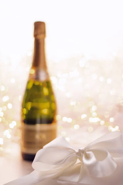 The bottle of champagne and holiday gift box — Stock Photo, Image